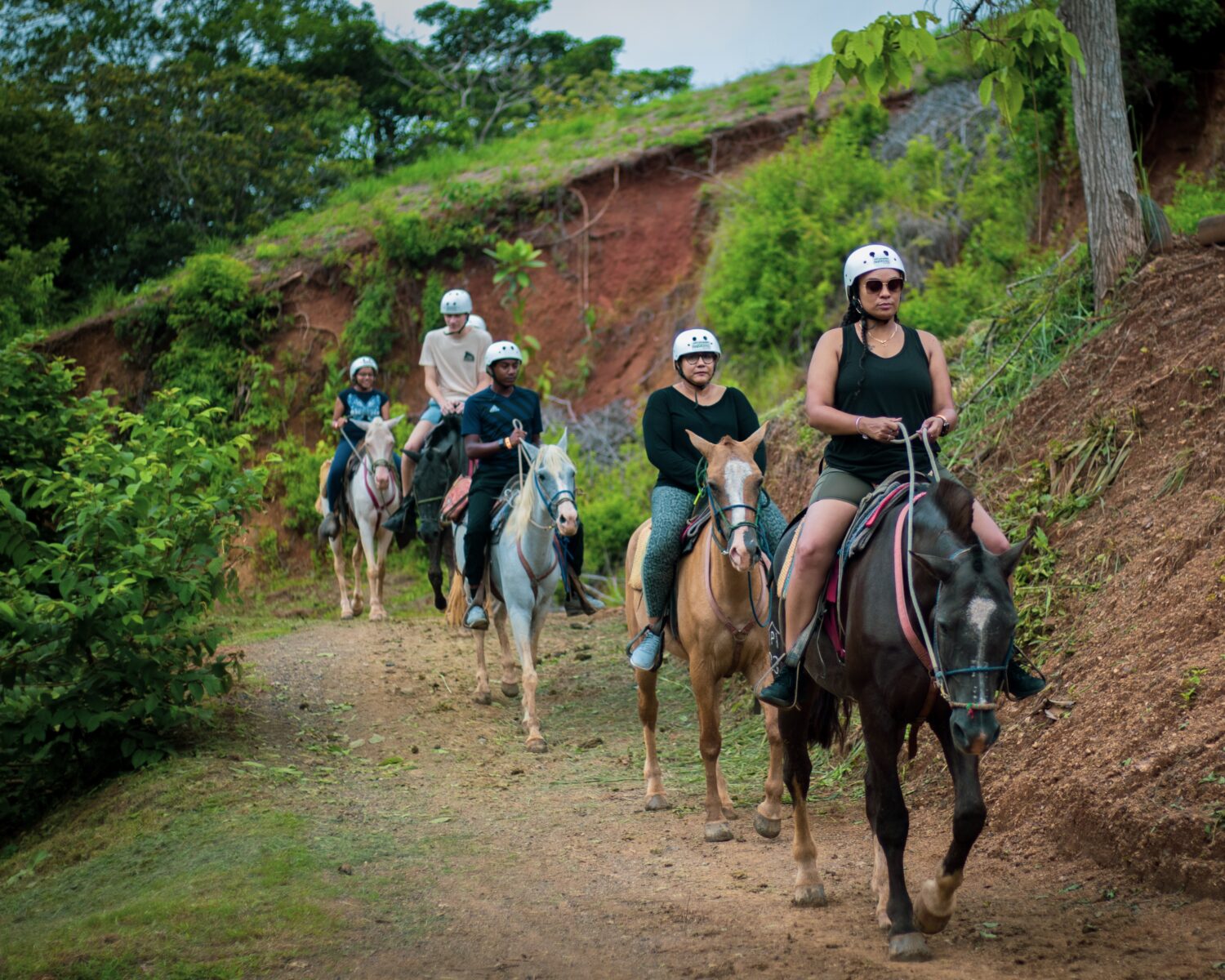 Cruise passengers horseback riding during the chocolate shore excursion at Vista Los Sueños